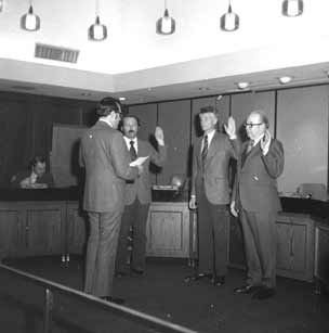 Three guys getting the oath.