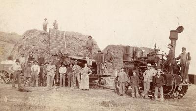Full hay wagon with crew around it.