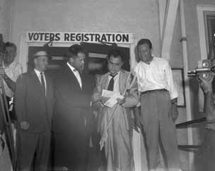 Todd with men in front of voters registration